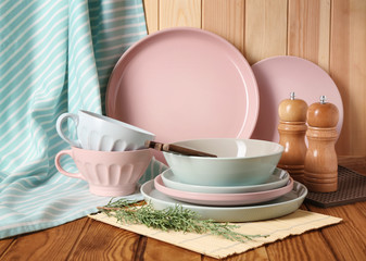 Set of clean dishware on wooden table