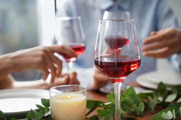 Glass of red wine on table set for party