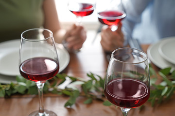 Glasses of red wine on table set for party
