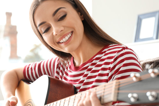 Beautiful Woman Playing Guitar At Home