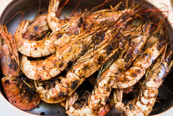 Appetizing grilled royal shrimp. Seafood grill on the stove, on the street food market.