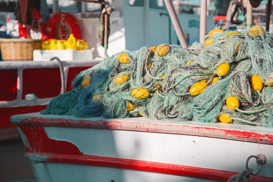 Nylon fishing net with float line attached to small plastic floats on boat in turkey
