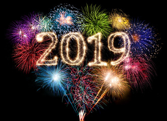 colorful fireworks display and bright sparkler pyrotechnic number 2019 happy new year background