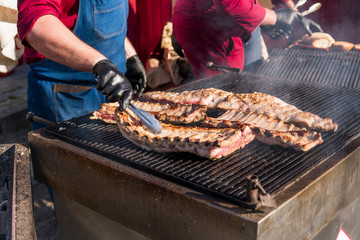Cooking pork ribs on a grill. Meat on a grills.