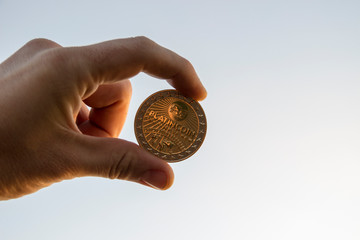 Cryptocurrency coin in hand