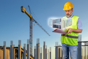 architect in costruction site with tablet displaying a hologram