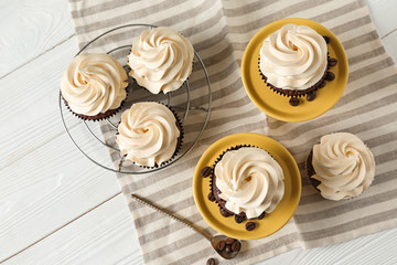Tasty chocolate cupcakes on white table