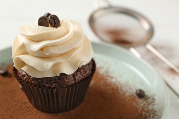 Tasty chocolate cupcake on plate, closeup