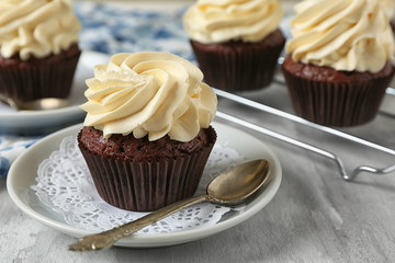 Tasty chocolate cupcake on plate