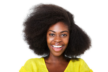 Close up happy young african american woman with afro hair laughing against isolated white...