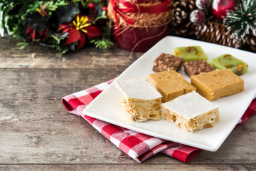 Christmas nougat on wooden table. Copyspace