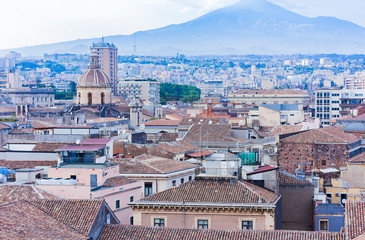 Fototapeta na wymiar Catania rooftops and cityscape with Mount Etna, active volcano in the background, Sicily, Italy