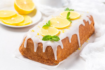 Lemon cake with sugar icing on a white background