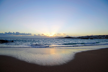 Fototapeta na wymiar Sunrise over the ocean. Beach and surf. Blue sky