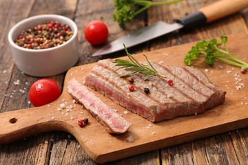 grilled beef on wooden board