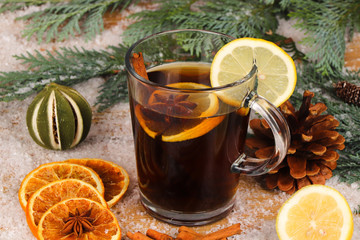 christmas tea or mulled wine on wooden table with snow  - christmas background