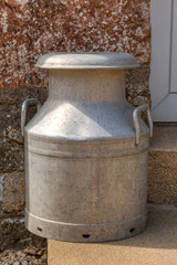 Traditional milk churn on a door step