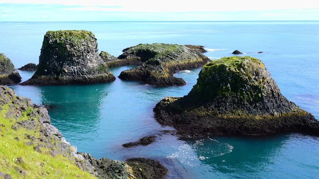 View of the basalt column rocks formation at the coastline of Atlantic Ocean at Arnarstapi Village in Iceland