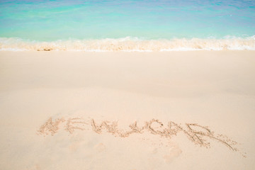 New 2019 year in the South, the sea. Sea surf. Blue wave is coming ashore. Inscription on sand