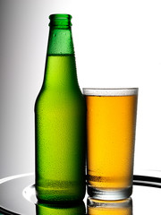 BOTTLE OF BEER AND GLASS