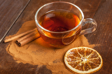 Cup with aromatic hot cinnamon tea on wooden table