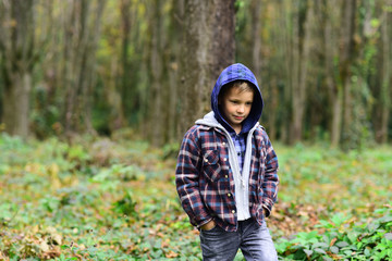 Naklejka na ściany i meble Fashion boy. Little kid in autumn forest. Kid with his own style. Autumn fashion trends for little children. Casual and lively