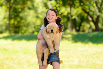 Portrait of girl holding puppy