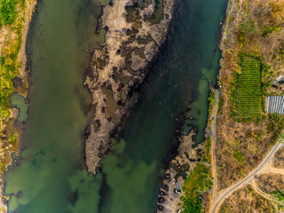 Top view aerial photo of green river pattern with sediment bar