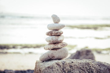 
Balanced Zen stones on blurred beach background, concept of balance and harmony