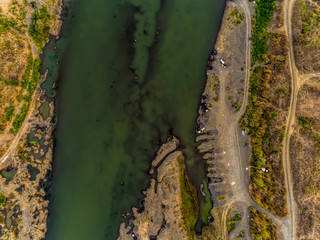 Top view aerial photo of green river pattern with sediment bar