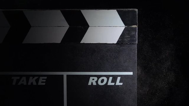 Film card with a cloud of chalk on black close up