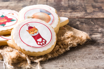 Homemade butter cookies with a printed Christmas cat design on wooden table