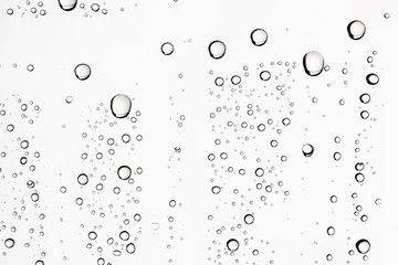 white isolated background water drops on the glass / wet window glass with splashes and drops of water and lime, texture autumn background