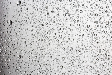 gray wet background / raindrops to overlay on the window, weather, background drops of water rain on the glass transparent
