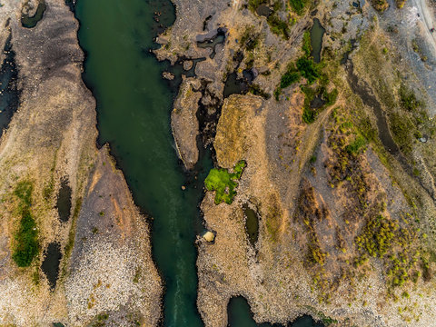 Top view aerial photo of green river pattern with sediment bar