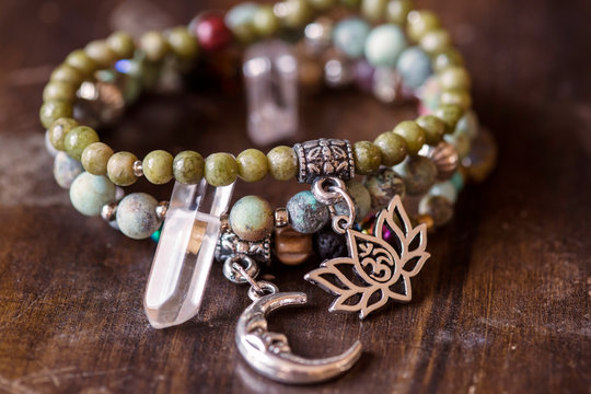 Three mineral stone bracelet with pendants on wooden background