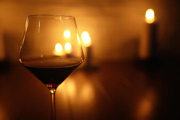 red wine glass serving / romantic dinner in the interior of the restaurant, a table served with a glass of grapes wine