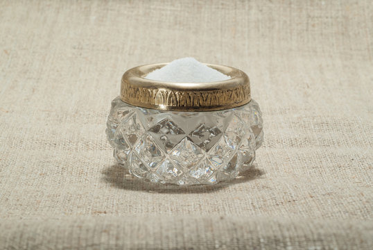 vintage crystal salt cellar on a simple canvas tablecloth