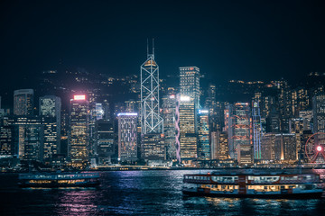 Ferry passing the Victoria Harbor  at night  in Hong Kong