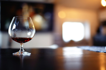 cognac in a glass, a beautiful wide cognac glass, the concept of luxury alcohol