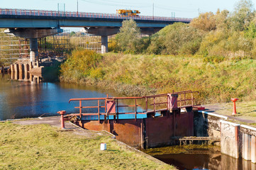 Gateway hydraulic structure old broken. Bridge over the channel with the gateway.