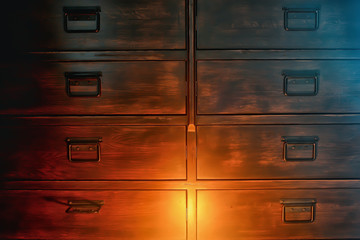 antique chest of drawers / background wooden boxes with handles in vintage wooden furniture wardrobe