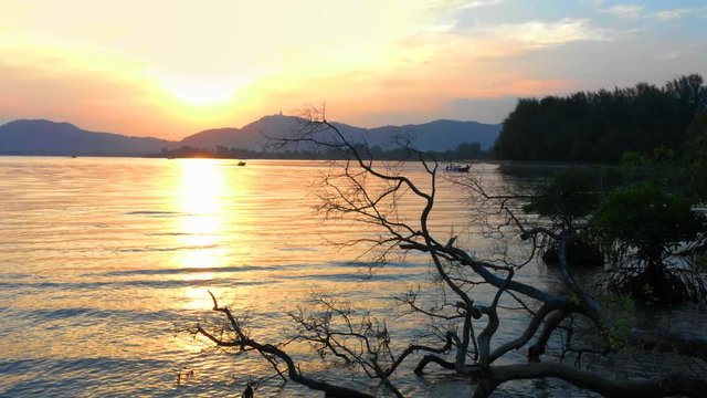 aerial view sunset in Mudong canal conect to Chalong bay. Klong Mudong canal has perfect mangrove forests..from here can see the Phuket big Buddha statue on the top of mountain.
