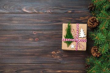 Christmas gift box wrapped in recycled paper, with ribbon bow, with ribbon on rustic background. Holiday concept