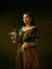 Fototapeta premium Girl in medieval beautiful dress or costume of the countess at dark studio.
