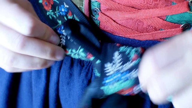 girl dresses a complex Tyrolean dress, typical of the traditional alpine areas of Tyrol