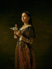 Obraz premium Girl in medieval beautiful dress or costume of the countess at dark studio.