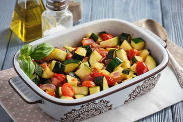 Sauteed zucchini with tomatoes and red onion.