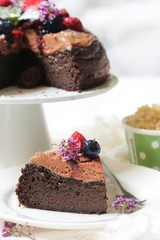 Homemade Chocolate Quinoa Cake topped with fruits and berries