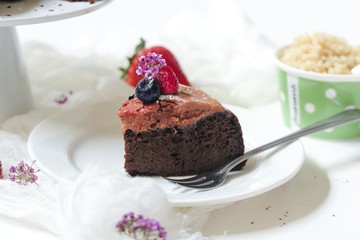 Homemade Chocolate Quinoa Cake topped with fruits and berries